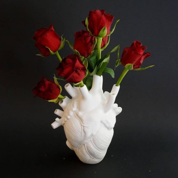 White anatomical heart vase with red roses