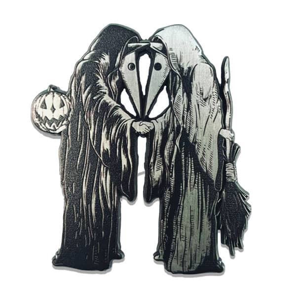 Two hooded figures with masks shaking hands holding a broom and jack o lantern