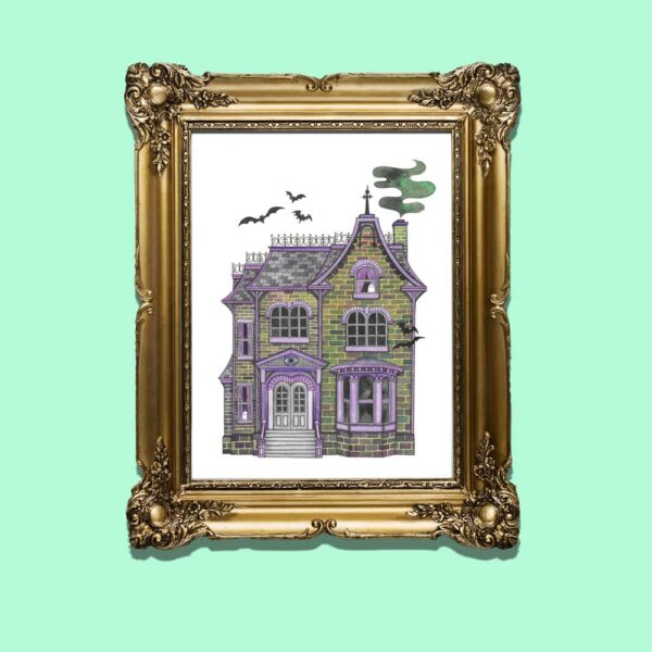Haunted House Art Print in gold wooden frame on green backdrop.