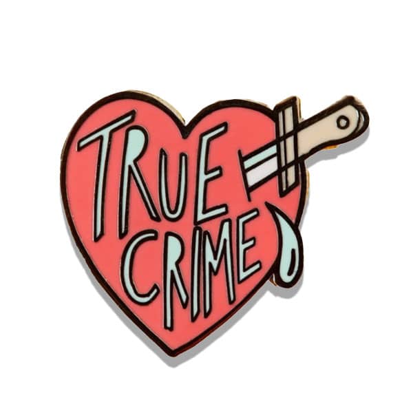 Heart with knife in it saying true crime pin.