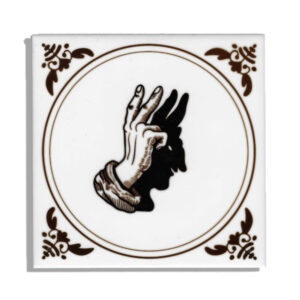 Ceramic tile with a hand holding a peace sign and it's shadow being a devil handpuppet