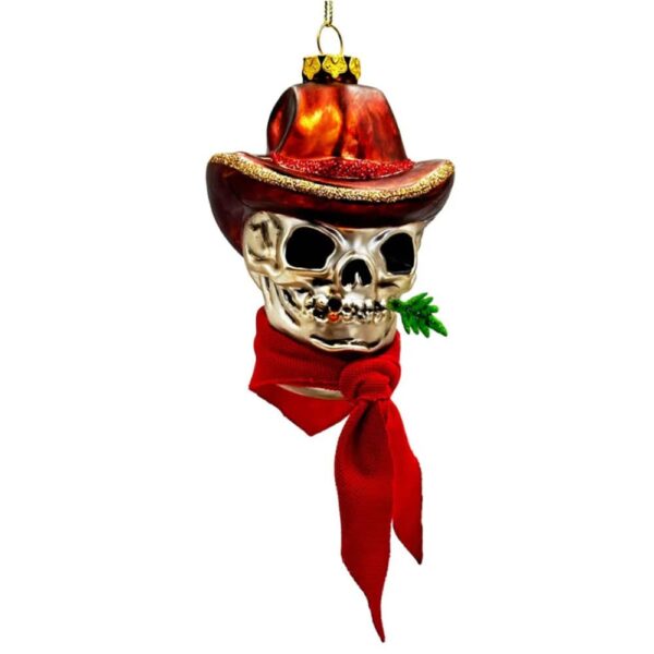 Glass Christmas ornament of a cowboy skull wearing a cowboy hat and red bandana chewing on holly