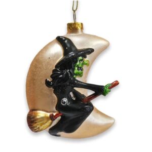 witch riding her broom in front of a moon glass christmas ornament